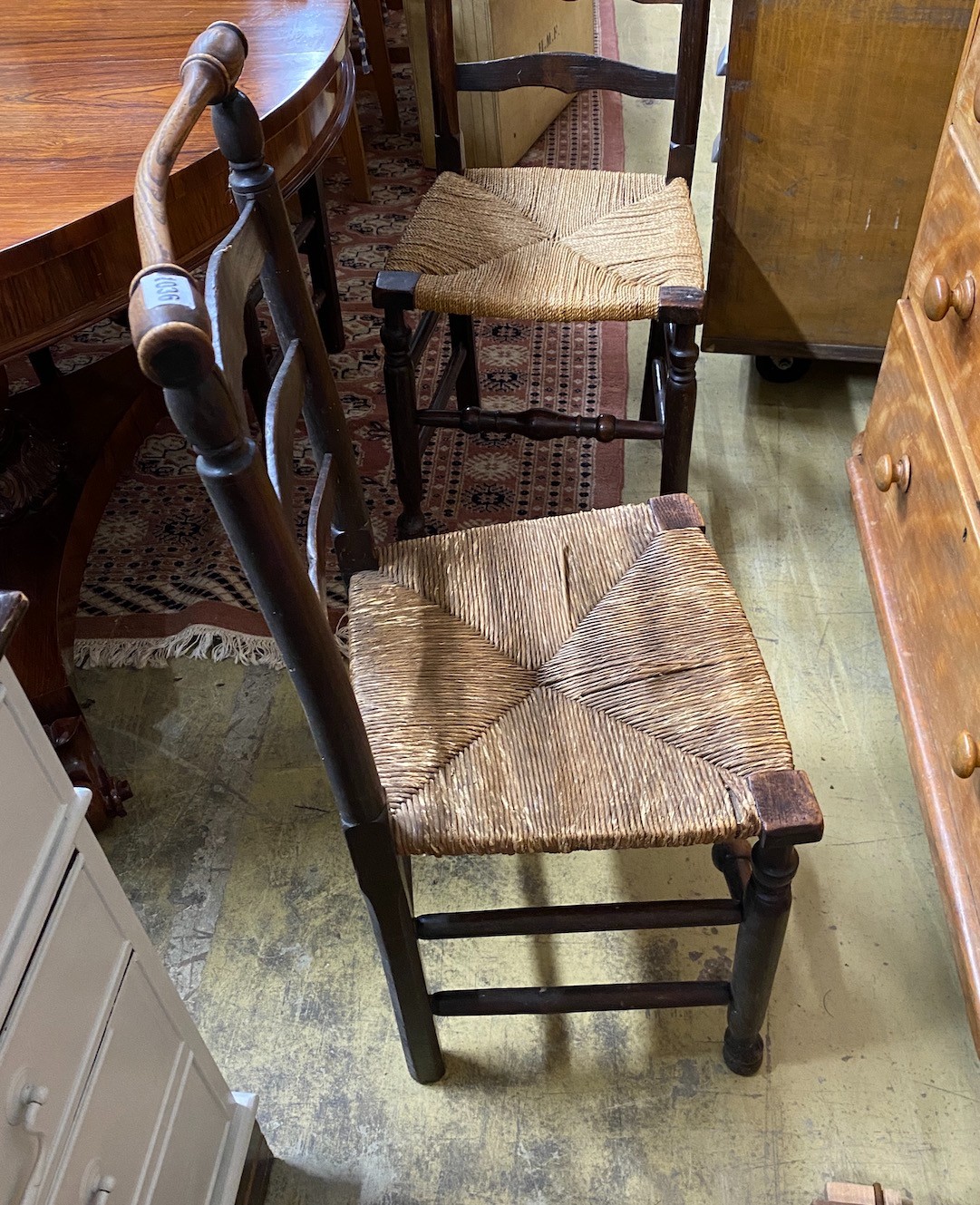 A set of six rush seated ladderback dining chairs